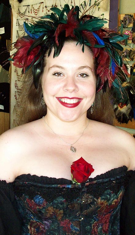 Black, red, blue, and green feathers adorn this stretchy feather headband